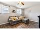 Living room with wood floors, a large sectional, and bright natural light at 16277 E Arkansas Dr, Aurora, CO 80017