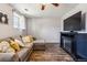 Living room with wood floors, a comfortable sectional, and an entertainment center at 16277 E Arkansas Dr, Aurora, CO 80017