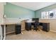 Well-lit office featuring modern desk, cabinets, and window for a productive workspace at 16277 E Arkansas Dr, Aurora, CO 80017