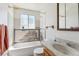 Bathroom with tub, and vanity in need of remodel at 1536 S Field Ct, Lakewood, CO 80232