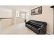 Living room with light carpet, black sofa and art piece at 2444 S Scranton Way, Aurora, CO 80014