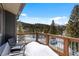 Relax on this balcony offering serene mountain views, complemented by rustic wood railings and comfortable seating at 112 Illinois Gulch Rd # 6, Breckenridge, CO 80424