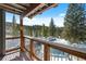 Covered balcony with wood accents and forest views at 112 Illinois Gulch Rd # 6, Breckenridge, CO 80424