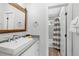 Bright bathroom with modern vanity and walk-in shower featuring black-and-white curtain at 112 Illinois Gulch Rd # 6, Breckenridge, CO 80424