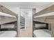 Unique bunkroom showcases sturdy beds with a spiral staircase, storage closets, and carpet flooring at 112 Illinois Gulch Rd # 6, Breckenridge, CO 80424