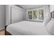 Bright bedroom featuring a comfy bed, large window with tree views, and soft curtains at 112 Illinois Gulch Rd # 6, Breckenridge, CO 80424