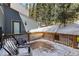 Snowy deck featuring seating and wooded backdrop at 112 Illinois Gulch Rd # 6, Breckenridge, CO 80424