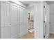 Well-lit hallway reveals closets, an open bathroom with a vanity, mirror, and a doorway at 112 Illinois Gulch Rd # 6, Breckenridge, CO 80424