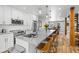 Bright, open kitchen with stainless appliances, island seating, and modern pendant lights at 112 Illinois Gulch Rd # 6, Breckenridge, CO 80424