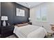Modern bedroom with dark accent wall, plantation shutters, and sleek furnishings, creating a cozy and stylish retreat at 25106 E 1St Ave, Aurora, CO 80018