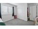 Bright bedroom featuring carpeted floor, white walls, and a closet with sliding doors at 25106 E 1St Ave, Aurora, CO 80018