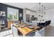 Modern dining area with rustic wood table and views into the kitchen and backyard at 25106 E 1St Ave, Aurora, CO 80018