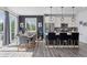 Open-concept dining area with modern decor, hardwood floors, and adjacent kitchen at 25106 E 1St Ave, Aurora, CO 80018