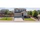 Front exterior of a two-story home with a well-kept lawn, driveway, and inviting landscaping at 25106 E 1St Ave, Aurora, CO 80018