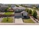 Charming two-story home with well-manicured front yard, lush green grass, and a paved driveway at 25106 E 1St Ave, Aurora, CO 80018