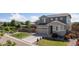 Charming two-story home features a manicured lawn, stone accents, and a spacious driveway leading to an attached garage at 25106 E 1St Ave, Aurora, CO 80018