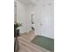 Bright hallway featuring hardwood floors, white trim, and a view into the bedroom, creating an inviting and seamless flow at 25106 E 1St Ave, Aurora, CO 80018
