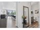 Hallway leading to a dining area and bathroom, with neutral decor and stylish accents, creating a harmonious and modern feel at 25106 E 1St Ave, Aurora, CO 80018