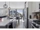 Bright kitchen features stainless appliances, white cabinets, and modern pendant lighting at 25106 E 1St Ave, Aurora, CO 80018