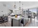 Open-concept kitchen with an island flows seamlessly into the living area and dining space, creating a perfect gathering spot at 25106 E 1St Ave, Aurora, CO 80018