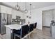 Kitchen features a large island with bar seating, stainless steel appliances, and modern lighting at 25106 E 1St Ave, Aurora, CO 80018