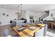 Open concept living area with dining table, kitchen with island, and staircase at 25106 E 1St Ave, Aurora, CO 80018