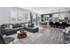 Bright living room with open layout to dining and kitchen areas, featuring hardwood floors and modern furnishings at 25106 E 1St Ave, Aurora, CO 80018