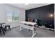 Office featuring a white desk, leather chair, black accent wall, and a large window at 25106 E 1St Ave, Aurora, CO 80018