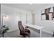 Office featuring a white desk, leather chair, closet with sliding doors, and art at 25106 E 1St Ave, Aurora, CO 80018