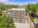 A view of a brick apartment building with trees, showcasing its exterior and surrounding landscape at 1050 N Lafayette St # 408, Denver, CO 80218