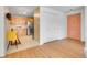 Inviting space with view of eat-in kitchen, and featuring wood-look floors, a white closet door and unique coral front door at 1050 N Lafayette St # 408, Denver, CO 80218
