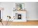 Inviting fireplace area with a charming mantel, elegant decor, and warm wood flooring at 1050 N Lafayette St # 408, Denver, CO 80218