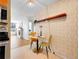 Bright kitchen nook with stylish wallpaper, a round table, and modern appliances at 1050 N Lafayette St # 408, Denver, CO 80218