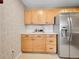 Well-lit kitchen features stainless steel refrigerator and classic cabinets at 1050 N Lafayette St # 408, Denver, CO 80218