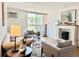 Bright living room featuring a fireplace, large window, and comfortable seating at 1050 N Lafayette St # 408, Denver, CO 80218