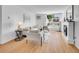 Bright living room with wood floors, white fireplace, and large window showcasing natural light and modern furnishings at 1050 N Lafayette St # 408, Denver, CO 80218