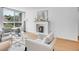 Bright living room with wood floors, white fireplace, and large window showcasing natural light and modern furnishings at 1050 N Lafayette St # 408, Denver, CO 80218