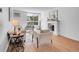 Bright living room with wood floors, white fireplace, and large window showcasing natural light and modern furnishings at 1050 N Lafayette St # 408, Denver, CO 80218