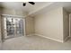 Bright bedroom with a sliding door to balcony and carpeted floors at 17497 Nature Walk Trl # 101, Parker, CO 80134