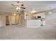 Open concept kitchen and living area with a breakfast bar and carpeted floors at 17497 Nature Walk Trl # 101, Parker, CO 80134