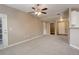 Spacious living room featuring carpet, ceiling fan, and access to other rooms at 17497 Nature Walk Trl # 101, Parker, CO 80134
