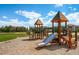 playground with slides, climbing structures, and a sandy play area at 17497 Nature Walk Trl # 101, Parker, CO 80134