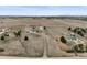 Property aerial view showcasing buildings, land, and distant town with open fields at 2845 Cherry Way, Parker, CO 80138
