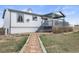 A spacious backyard with a covered patio, lush greenery, and a charming stone pathway at 2845 Cherry Way, Parker, CO 80138