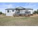 Inviting backyard with covered patio, gray railings and steps down to yard at 2845 Cherry Way, Parker, CO 80138