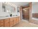 Well-appointed bathroom with double vanities, a tiled shower, and a soaking tub at 2845 Cherry Way, Parker, CO 80138