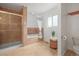 Bright bathroom featuring tiled shower and tub combination and convenient window for natural light at 2845 Cherry Way, Parker, CO 80138