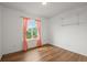 Bright bedroom with hardwood floors, shelf and natural light from the window with patterned curtains at 2845 Cherry Way, Parker, CO 80138