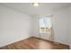 Bright bedroom features laminate flooring and a window with peaceful exterior views at 2845 Cherry Way, Parker, CO 80138