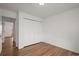 Bedroom with hardwood floors, overhead lighting and a large closet with folding doors at 2845 Cherry Way, Parker, CO 80138
